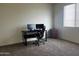 Home office with a computer desk, office chair, storage, and a carpeted floor at 17622 W Missouri Ave, Litchfield Park, AZ 85340