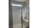 Bright shower featuring a glass door, shower bench and natural light at 17622 W Missouri Ave, Litchfield Park, AZ 85340