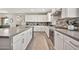 Bright kitchen featuring white cabinetry, stainless steel oven, and light wood-look flooring at 17819 E Oak Creek Canyon Ln, Rio Verde, AZ 85263