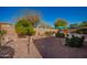 Well-maintained backyard with landscaping, desert foliage, and decorative rock ground cover at 18813 N Summerbreeze Way, Surprise, AZ 85374