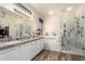 Bathroom features dual sinks, granite counters, soaking tub, and glass-enclosed shower at 18813 N Summerbreeze Way, Surprise, AZ 85374
