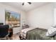 Bedroom featuring a workspace by the window and a comfortable bed at 18813 N Summerbreeze Way, Surprise, AZ 85374