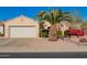 Charming single-story home featuring a two-car garage, mature landscaping, and a well-maintained desert-style front yard at 18813 N Summerbreeze Way, Surprise, AZ 85374