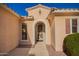 Close-up of a welcoming front entrance with a decorative security door and desert-themed accents enhancing the home's appeal at 18813 N Summerbreeze Way, Surprise, AZ 85374