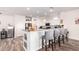 Open kitchen design with barstool seating, granite countertops, and stainless steel appliances at 18813 N Summerbreeze Way, Surprise, AZ 85374
