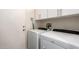 Clean laundry room with white washer and dryer, white cabinets, and a white door at 18813 N Summerbreeze Way, Surprise, AZ 85374