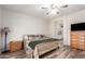 Well-lit bedroom features wood-look floors, neutral walls, and traditional furnishings at 18813 N Summerbreeze Way, Surprise, AZ 85374