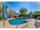 Sparkling pool featuring desert landscaping, rock waterfall and an umbrella at 18813 N Summerbreeze Way, Surprise, AZ 85374
