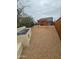 Charming backyard featuring gravel, wooden pergola, and a concrete outdoor kitchen with blue tile details at 1953 W Granada Rd, Phoenix, AZ 85009