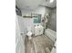 Updated bathroom featuring modern fixtures, a shower-tub combo, and wood-look flooring at 1953 W Granada Rd, Phoenix, AZ 85009