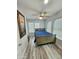 Bright bedroom with a ceiling fan, and wood-look flooring, filled with natural light from multiple windows at 1953 W Granada Rd, Phoenix, AZ 85009
