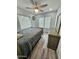 Cozy bedroom with a ceiling fan, and wood-look flooring, filled with natural light from multiple windows at 1953 W Granada Rd, Phoenix, AZ 85009