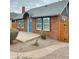 A quaint brick house showcases a blue front door and xeriscaping, blending charm with water conservation at 1953 W Granada Rd, Phoenix, AZ 85009