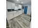 Bright, modern kitchen featuring white cabinets, stainless steel appliances, and sleek countertops at 1953 W Granada Rd, Phoenix, AZ 85009