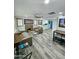 Spacious living room showcasing a stone fireplace, modern furnishings, and seamless flow into the updated kitchen at 1953 W Granada Rd, Phoenix, AZ 85009