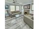 Cozy living area featuring a stone fireplace, neutral furnishings, and ample natural light from large windows at 1953 W Granada Rd, Phoenix, AZ 85009