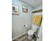 Bathroom with a toilet, towel rack, and framed artwork at 1953 W Granada Rd, Phoenix, AZ 85009