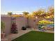 Landscaped backyard featuring desert plants, artificial grass, and vibrant mural on the fence at 20012 W Campbell Ave, Buckeye, AZ 85396