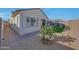 Well-maintained backyard with rockscape, grass patch, and a charming small tree at 20012 W Campbell Ave, Buckeye, AZ 85396