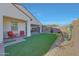 Backyard featuring desert landscaping, covered patio, and well kept turf at 20012 W Campbell Ave, Buckeye, AZ 85396