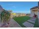Manicured backyard with desert landscaping, turf, and patio seating at 20012 W Campbell Ave, Buckeye, AZ 85396