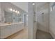 Bright bathroom featuring dual sink vanity with white cabinets and stylish walk-in shower at 20012 W Campbell Ave, Buckeye, AZ 85396