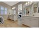 Bright bathroom features dual sinks with white cabinets, quartz countertop, and plantation shutters at 20012 W Campbell Ave, Buckeye, AZ 85396
