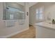 This light and bright bathroom showcases a glass shower and decorative tile accent at 20012 W Campbell Ave, Buckeye, AZ 85396