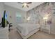Charming bedroom features floral wallpaper accent, ceiling fan, and window with shutters at 20012 W Campbell Ave, Buckeye, AZ 85396