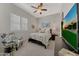 Stylish bedroom featuring plantation shutters, a ceiling fan, and a decorative accent wall at 20012 W Campbell Ave, Buckeye, AZ 85396