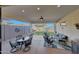 Covered patio with two seating areas and outdoor ceiling fan at 20012 W Campbell Ave, Buckeye, AZ 85396