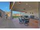 Covered patio and manicured yard area with mural on privacy wall at 20012 W Campbell Ave, Buckeye, AZ 85396
