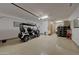 Well-lit garage with golf cart, storage cabinets, and epoxy-coated floor at 20012 W Campbell Ave, Buckeye, AZ 85396