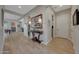 Hallway with wood-look tile, console table and decorative lamps and artwork on the wall at 20012 W Campbell Ave, Buckeye, AZ 85396