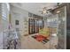 Hobby room with collectible displays, light wood floors, and ceiling fan at 20012 W Campbell Ave, Buckeye, AZ 85396