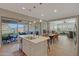 Open-concept kitchen flows to dining and living areas with backyard view at 20012 W Campbell Ave, Buckeye, AZ 85396