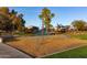 Community playground with modern climbing structure, surrounded by lush landscaping and well-maintained green space at 21973 E Camina Plata --, Queen Creek, AZ 85142