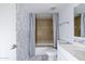Bright bathroom featuring a tub with tiled surround and stylish patterned wallpaper at 2401 N 70Th St # G, Scottsdale, AZ 85257