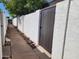 View of fence with river rock landscaping offering curb appeal and privacy at 2401 N 70Th St # G, Scottsdale, AZ 85257
