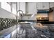 Modern kitchen with granite countertops, stainless steel sink, and backsplash at 2401 N 70Th St # G, Scottsdale, AZ 85257