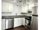 Well-lit kitchen features stainless steel appliances, dark countertops, and white cabinetry at 2401 N 70Th St # G, Scottsdale, AZ 85257