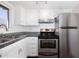 Bright kitchen with stainless steel appliances, white cabinetry and granite countertops at 2401 N 70Th St # G, Scottsdale, AZ 85257
