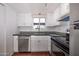 Well-lit kitchen with stainless steel appliances, and white cabinets at 2401 N 70Th St # G, Scottsdale, AZ 85257