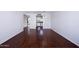 Open living room with hard wood floors leading to kitchen area at 2401 N 70Th St # G, Scottsdale, AZ 85257