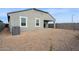 Open backyard with desert landscaping, side brick fence, and a covered patio area at 25449 W Graham Trl, Buckeye, AZ 85326