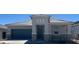 Beautiful single-story home with neutral colors, a two-car garage, and appealing desert landscaping at 25449 W Graham Trl, Buckeye, AZ 85326