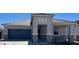 Beautiful single-story home with neutral colors, a two-car garage, and appealing desert landscaping at 25449 W Graham Trl, Buckeye, AZ 85326