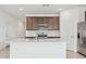 Open kitchen with a large island, stainless steel appliances, and dark wood cabinets at 25449 W Graham Trl, Buckeye, AZ 85326
