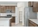Modern kitchen features stainless steel appliances, a walk-in pantry, and stylish countertops at 25449 W Graham Trl, Buckeye, AZ 85326