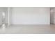Spacious living room with neutral tile flooring and access to additional rooms at 25449 W Graham Trl, Buckeye, AZ 85326